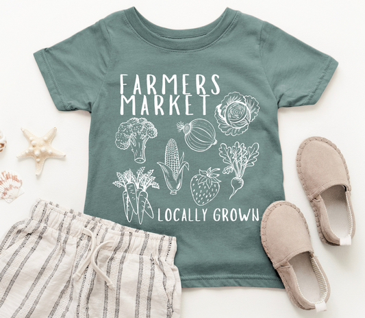Children's t-shirt with 'Farmers Market Locally Grown' design, shorts, and shoes on a white background
